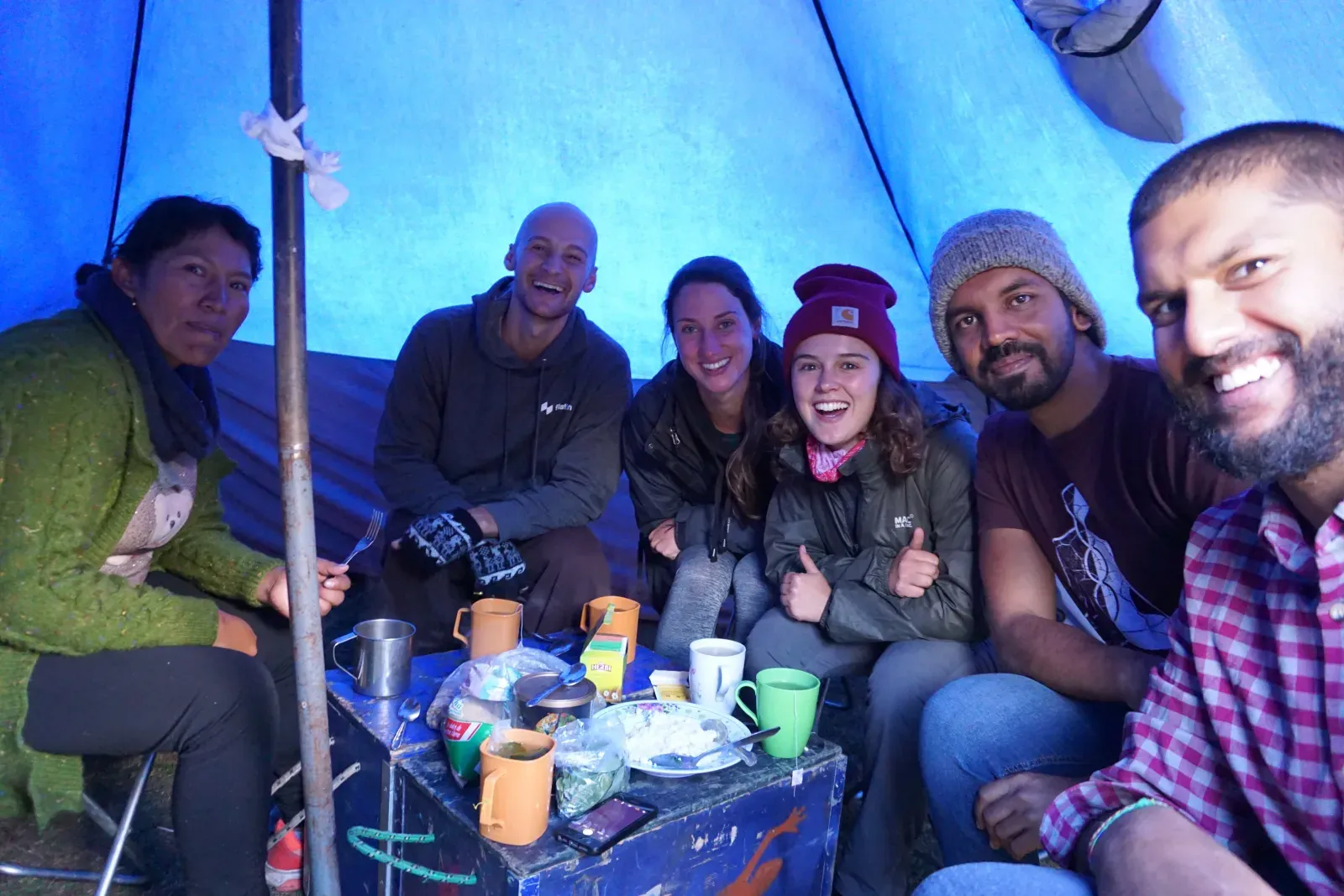 Our 2019 group smiling around the table in the dining tent